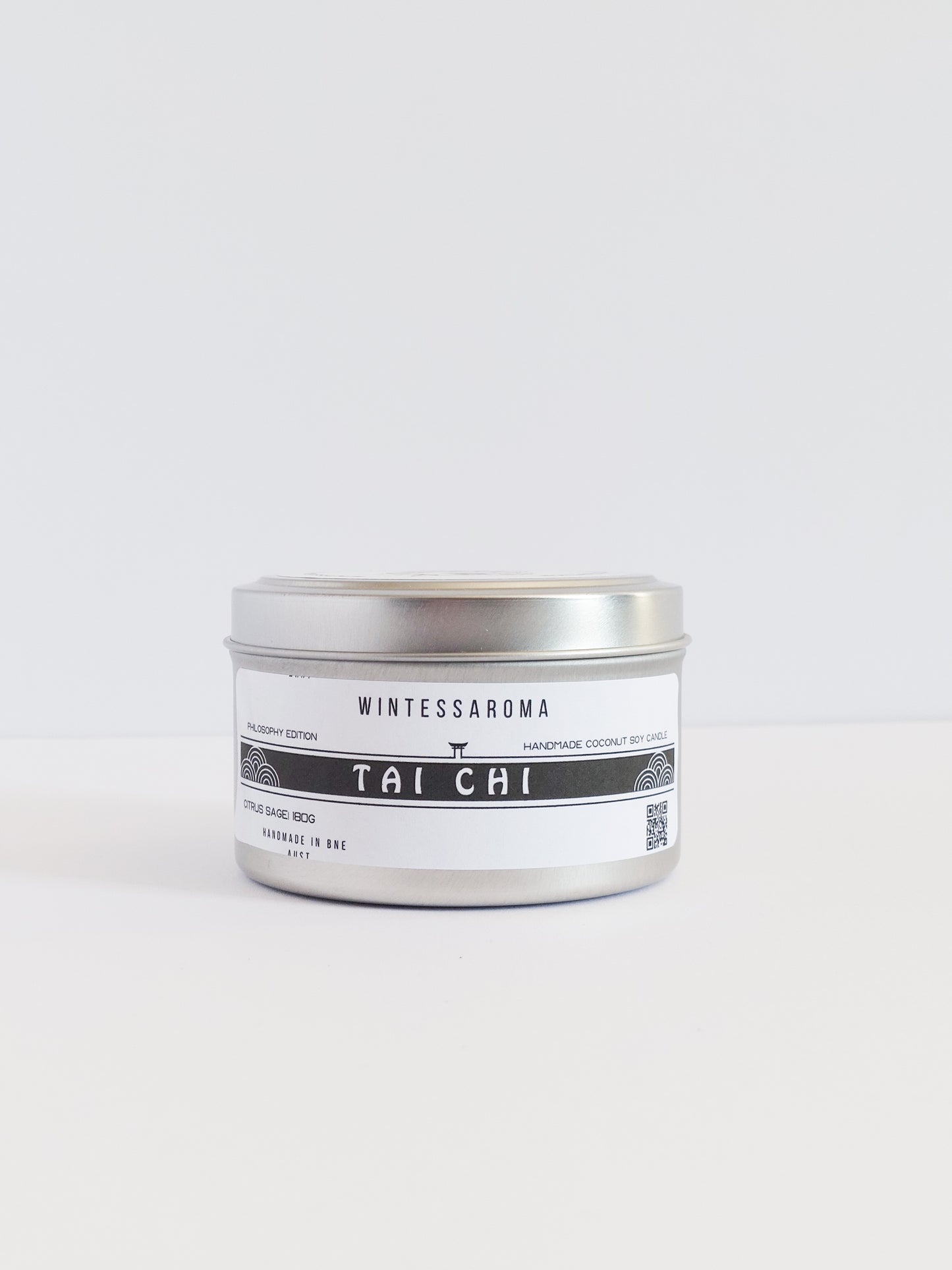 A metal candle jar with a label that reads 'Wintersaroma | Tai Chi'.