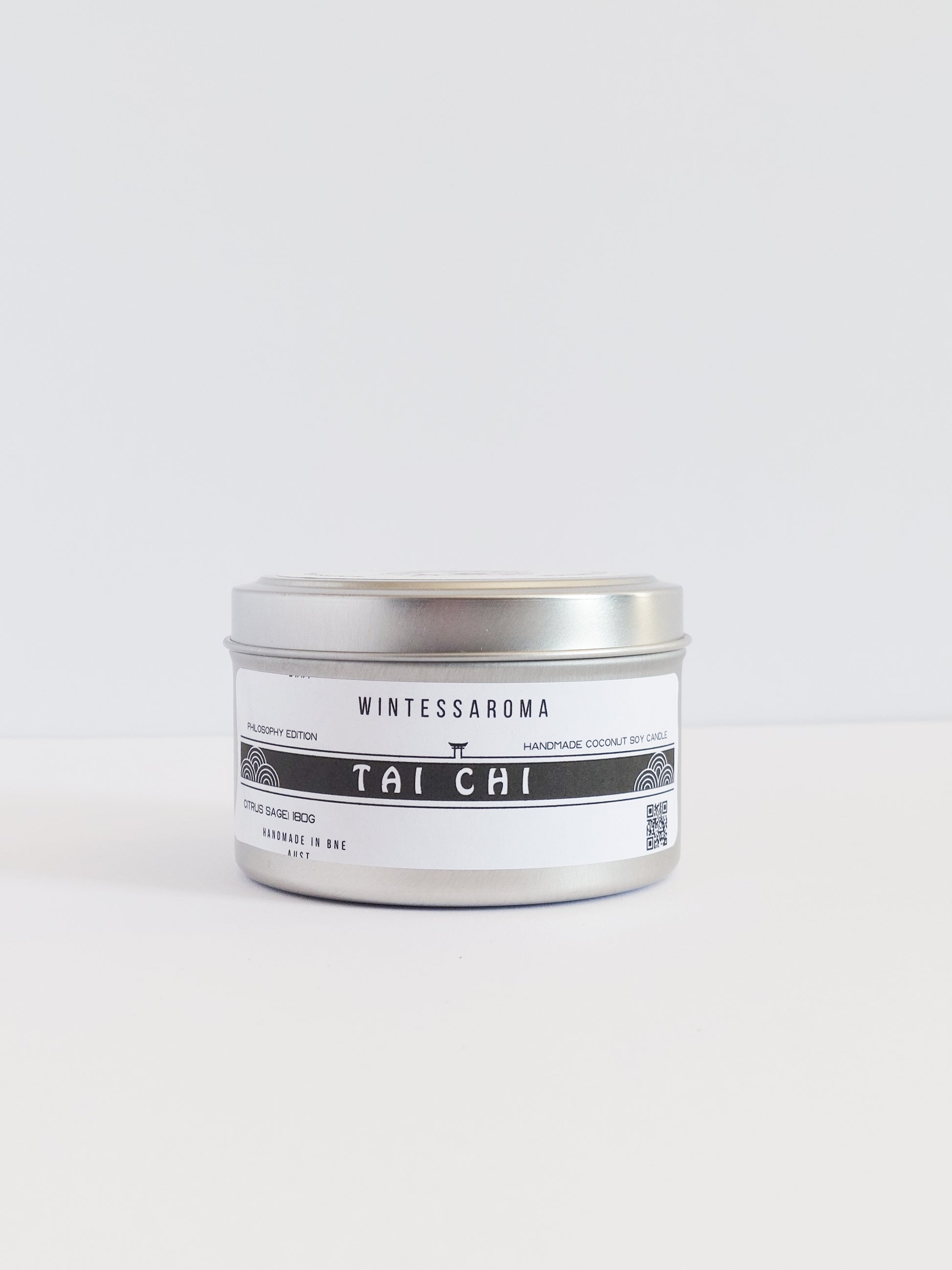 A metal candle jar with a label that reads 'Wintersaroma | Tai Chi'.