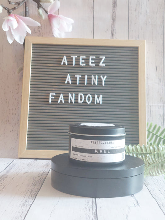 Candle on a stand with a letterboard displaying 'ATEEZ ATINY FANDOM' against a light wooden background. Front View