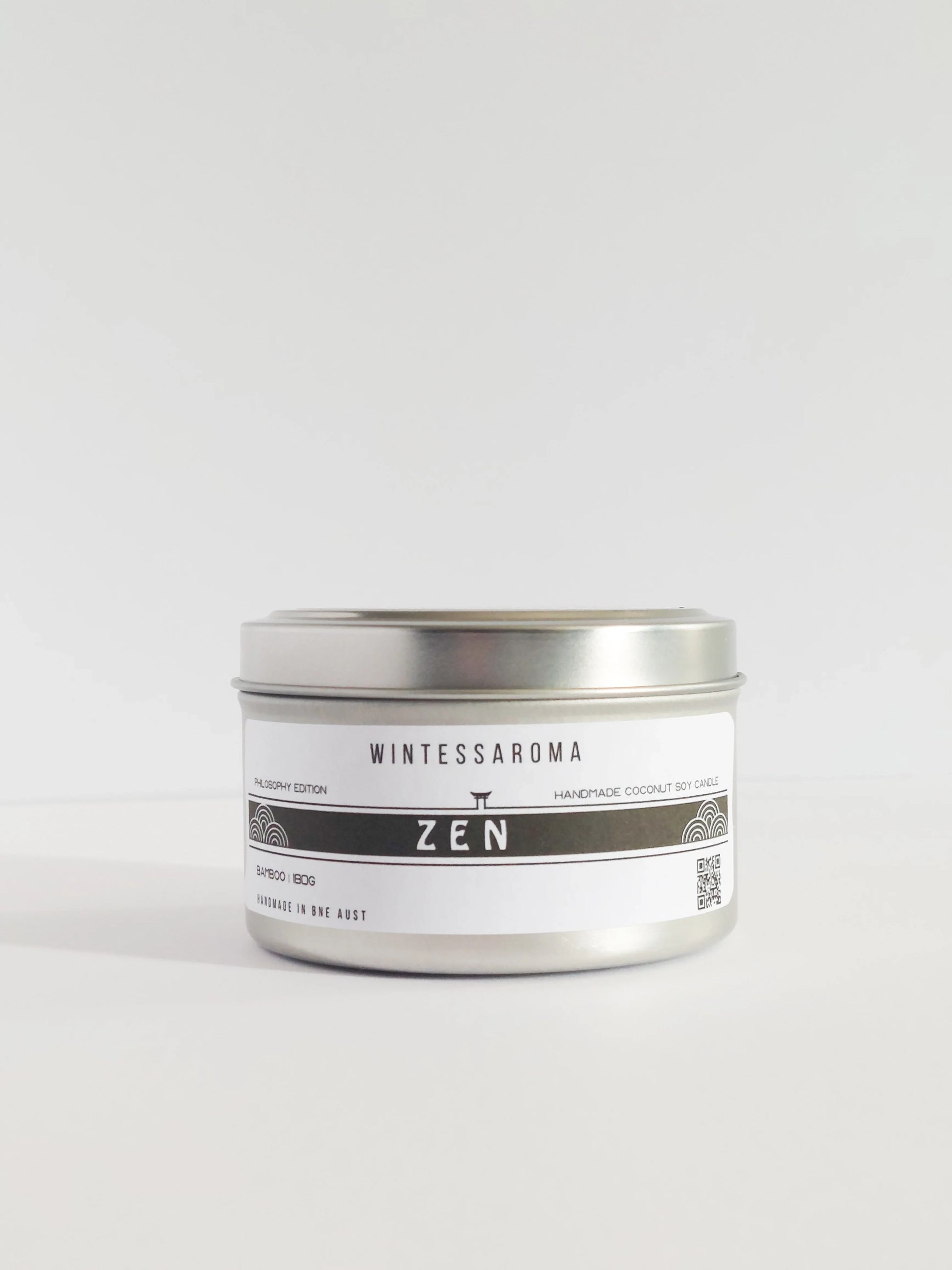 Candle in a silver tin labeled 'Wintessaroma Zen' on a white background