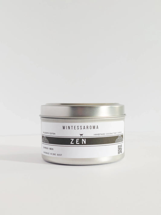 Candle in a silver tin labeled 'Wintessaroma Zen' on a white background